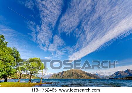 High altitude cirrus cloud streaks over lake Wanaka, South Island, New Zealand View Large Photo Image Stock Photography - High altitude cirrus cloud streaks over lake Wanaka, South Island, New Zealand. Fotosearch