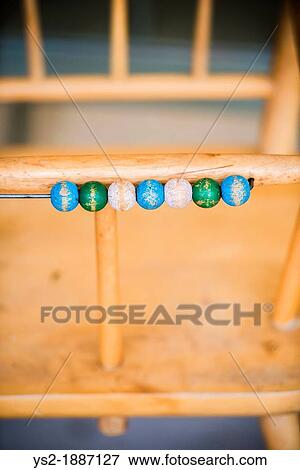 High chair used for small children with wooden pebbles used for counting View Large Photo Image Stock Photo - High chair used for small children with wooden pebbles used for counting. Fotosearch