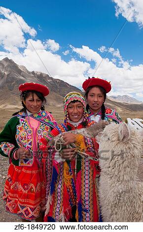 Stock Image - High peak at 13, 000 feet of La Raya Peru with young children with llama portrait. Fotosearch