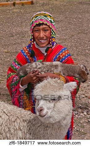 Stock Photo - High peak at 13, 000 feet of La Raya Peru with young boy with llama portrait. Fotosearch