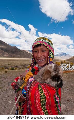 Stock Photo - High peak at 13, 000 feet of La Raya Peru with young boy with llama portrait. Fotosearch