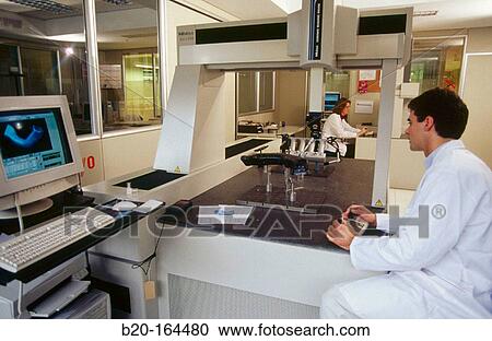 Stock Image - High precision metrology, coordinate measuring machine, plastic car engine component. Fotosearch