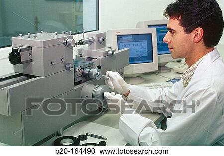 Stock Image - High precision metrology, coordinate measuring machine, car engine component. Fotosearch