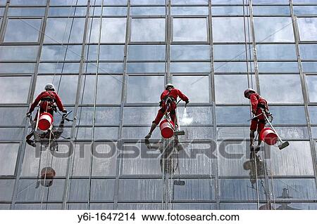 High rise window cleaners work suspended on ropes Orchard Road Singapore View Large Photo Image Picture - High rise window cleaners work suspended on ropes Orchard Road Singapore. Fotosearch