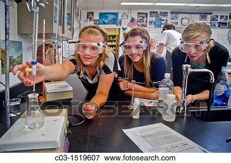 Stock Photo - High school chemistry students in San Clemente, CA, perform an experiment using titration, a method of quantitative chemical analysis. Fotosearch