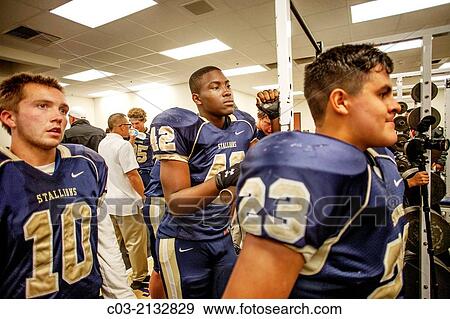 High school football players listen to their coach during half time of a night game in San Juan Capistrano, CA. View Large Photo Image Stock Photo - High school football players listen to their coach during half time of a night game in San Juan Capistrano, CA.. Fotosearch