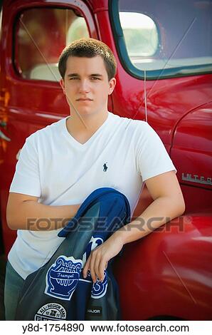 Highschool senior, male caucasian, 17 years old, posing with his school letterman jacket next to vintage automobile View Large Photo Image Stock Image - Highschool senior, male caucasian, 17 years old, posing with his school letterman jacket next to vintage automobile. Fotosearch