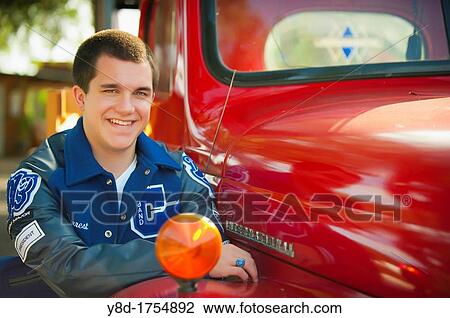 Highschool senior, male caucasian, 17 years old, posing with his school letterman jacket next to vintage automobile View Large Photo Image Stock Image - Highschool senior, male caucasian, 17 years old, posing with his school letterman jacket next to vintage automobile. Fotosearch