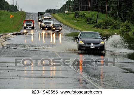 Highway 2 traffic negotiating flooded road, Duluth, Miinesota, USA. View Large Photo Image Stock Photography - Highway 2 traffic negotiating flooded road, Duluth, Miinesota, USA.. Fotosearch