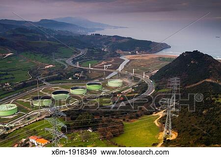 Stock Photo - Highway and oil refinery tanks. Fotosearch