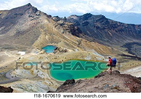 Hiker above Emerald Lakes, Tongariro National Park, central north island, New Zealand View Large Photo Image Stock Photo - Hiker above Emerald Lakes, Tongariro National Park, central north island, New Zealand. Fotosearch