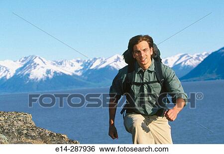 Stock Photograph - Hiker along Turnagain Arm in summer. Chugach State Park. Alaska. Fotosearch