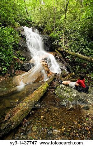 Hiker by Log Hollow Falls - Pisgah National Forest - near Brevard, North Carolina USA View Large Photo Image Stock Photo - Hiker by Log Hollow Falls - Pisgah National Forest - near Brevard, North Carolina USA. Fotosearch
