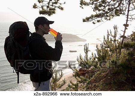 Hiker drinking water along Pacific Ocean Trail. Santa Cruz, California View Large Photo Image Stock Photograph - Hiker drinking water along Pacific Ocean Trail. Santa Cruz, California. Fotosearch