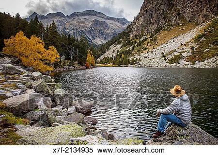 Hiker. `Estany Llong?,Llong lake, Aig? estortes i Estany de Sant Maurici National Park, Pyrenees, Lleida province, Catalonia, Spain. View Large Photo Image Stock Photography - Hiker. `Estany Llong?,Llong lake, Aig? estortes i Estany de Sant Maurici National Park, Pyrenees, Lleida province, Catalonia, Spain.. Fotosearch