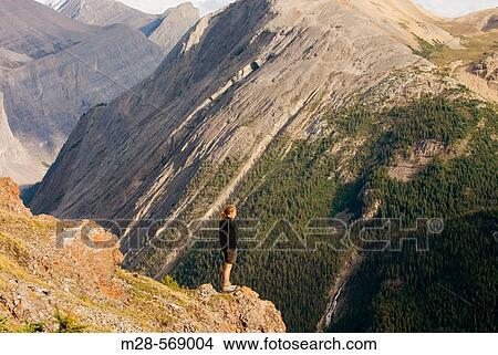 Hiker gazing at views from Parker Ridge, Banff National Park. Canada View Large Photo Image Picture - Hiker gazing at views from Parker Ridge, Banff National Park. Canada. Fotosearch