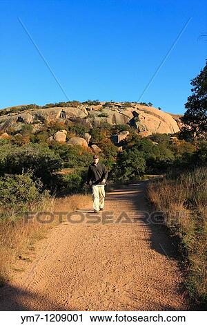 Stock Image - Hiker on Echo Canyon Trail - Enchanted Rock SNA, Texas. Fotosearch