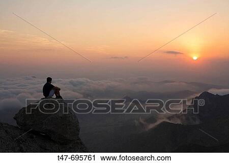 Hiker on the top of Maigm? mountains in the evening. Alicante province, Comunidad Valenciana, Spain View Large Photo Image Stock Image - Hiker on the top of Maigm? mountains in the evening. Alicante province, Comunidad Valenciana, Spain. Fotosearch