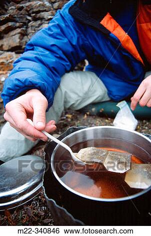 Stock Photograph - Hiker preparing an evening tea. White goat Wilderness Area. Alberta. Canada. Fotosearch