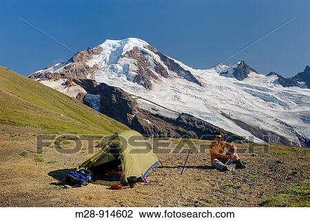 Hiker relaxing at an alpine camp on Chowder Ridge with Mount Baker elevation 10, 778feet 3, 285m in the distance Mount Baker Wilderness Washington USA View Large Photo Image Stock Image - Hiker relaxing at an alpine camp on Chowder Ridge with Mount Baker elevation 10, 778feet 3, 285m in the distance Mount Baker Wilderness Washington USA. Fotosearch