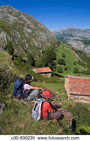 Stock Photography - Hiker resting in the Invernales de Panizales, of the small town of Bejes, in the municipality of Cillorigo de Li? bana, in Cantabria, Spain. Fotosearch