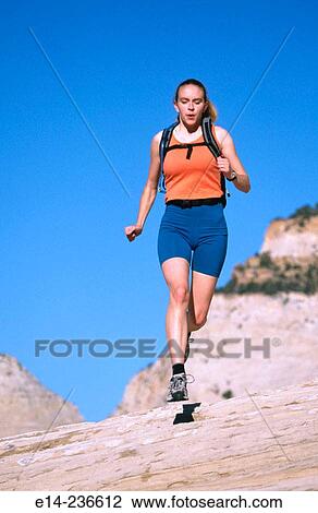 Hiker running on slick rock at Zion National Park. Utah. USA View Large Photo Image Stock Image - Hiker running on slick rock at Zion National Park. Utah. USA. Fotosearch