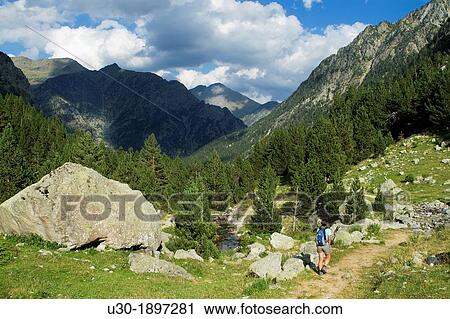 Hiker walking along Barrosa valley, a typical glacier valley of aragonese Pyrenees Huesca Spain View Large Photo Image Stock Image - Hiker walking along Barrosa valley, a typical glacier valley of aragonese Pyrenees Huesca Spain. Fotosearch