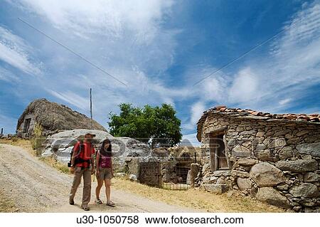 Hiker walking in front of a traditional cabins in Navalosa, Sierra De Gredos? vila Castilla y Le? n Spain View Large Photo Image Stock Photo - Hiker walking in front of a traditional cabins in Navalosa, Sierra De Gredos? vila Castilla y Le? n Spain. Fotosearch