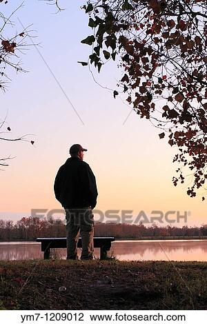 Hiker Watching the Sunset - George Bush Park, Harris County, Texas Lake near the Noble Road Trail View Large Photo Image Stock Image - Hiker Watching the Sunset - George Bush Park, Harris County, Texas Lake near the Noble Road Trail. Fotosearch