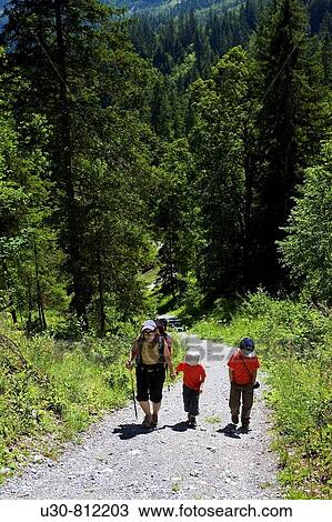 Hiker with children, crossing a forest at the foot of the Eiger Berneses Alps, Switzerland View Large Photo Image Stock Image - Hiker with children, crossing a forest at the foot of the Eiger Berneses Alps, Switzerland. Fotosearch