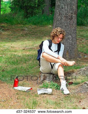 Hiker woman with pain on her feet View Large Photo Image Stock Photo - Hiker woman with pain on her feet. Fotosearch