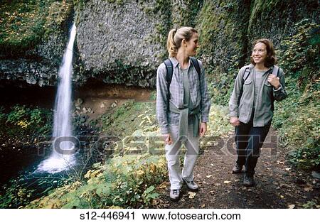 Stock Image - Hikers and Ponytail Falls. Columbia River Gorge. Oregon. USA.. Fotosearch