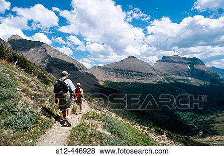 Stock Photo - Hikers at Piegan Pass. Mt. Glacier National Park. USA.. Fotosearch