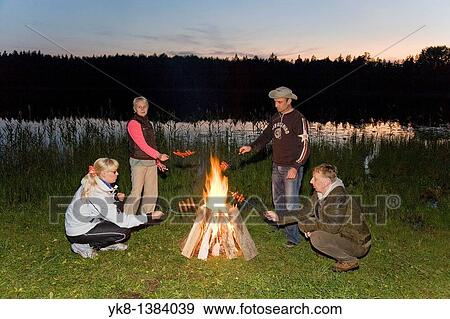 Hikers Companion by Campfire near Water in Night View Large Photo Image Stock Photo - Hikers Companion by Campfire near Water in Night. Fotosearch