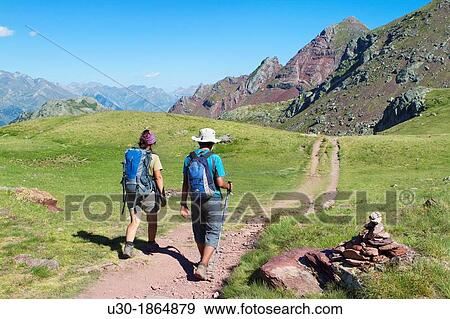 Stock Photo - Hikers going down from summit of Anayet, an old volcano in Tena valley Formigal Sallent de GBllego Pyrenees Huesca province Arag? n Spain. Fotosearch