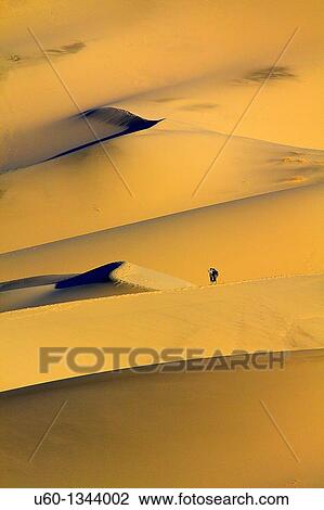 Hikers make their way up Eureka Dunes at Death Valley National Park View Large Photo Image Stock Image - Hikers make their way up Eureka Dunes at Death Valley National Park. Fotosearch
