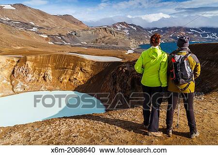 Stock Image - Hikers near Viti geothermal lake and Askja caldera. Central Highlands. Iceland, Europe.. Fotosearch