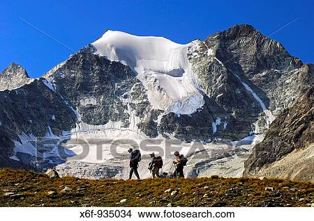 Hikers on the way to the Moiry hut passing Mt Pointes de Mourti, Pennine Alps, Valais, Switzerland View Large Photo Image Picture - Hikers on the way to the Moiry hut passing Mt Pointes de Mourti, Pennine Alps, Valais, Switzerland. Fotosearch