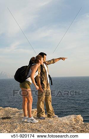 Hikers overlooking the sea View Large Photo Image Picture - Hikers overlooking the sea. Fotosearch