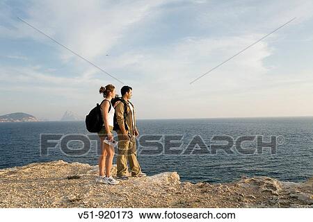 Hikers overlooking the sea View Large Photo Image Stock Image - Hikers overlooking the sea. Fotosearch