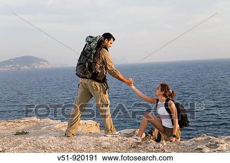 Hikers overlooking the sea View Large Photo Image Stock Image - Hikers overlooking the sea. Fotosearch