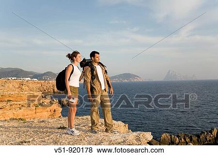 Hikers overlooking the sea View Large Photo Image Stock Photo - Hikers overlooking the sea. Fotosearch