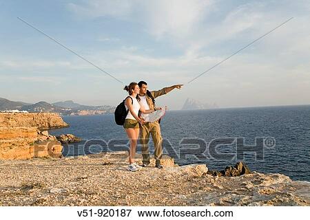 Hikers overlooking the sea View Large Photo Image Stock Photo - Hikers overlooking the sea. Fotosearch