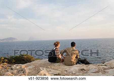 Hikers overlooking the sea View Large Photo Image Stock Photograph - Hikers overlooking the sea. Fotosearch