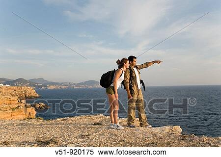 Hikers overlooking the sea View Large Photo Image Stock Photography - Hikers overlooking the sea. Fotosearch