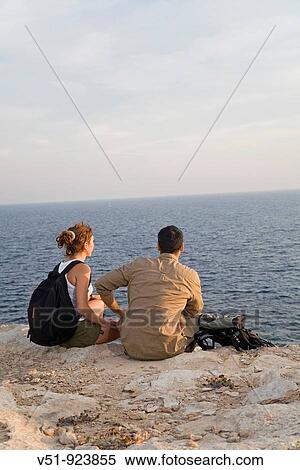Hikers overlooking the sea View Large Photo Image Stock Photography - Hikers overlooking the sea. Fotosearch