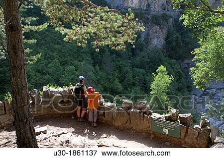 Hikers resting in a viewpoint of Aisclo Valley, canyon belonging to Ordesa y Monte Perdido National Park Pyrenees Fanlo Huesca province Arag? n Spain View Large Photo Image Stock Photo - Hikers resting in a viewpoint of Aisclo Valley, canyon belonging to Ordesa y Monte Perdido National Park Pyrenees Fanlo Huesca province Arag? n Spain. Fotosearch
