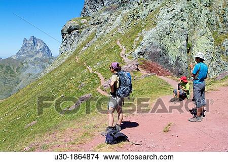 Hikers resting next to Anayet peak, an old volcano in Tena valley, and view of Midi d? Ossau Peak France Formigal Sallent de GBllego Pyrenees Huesca province Arag? n Spain View Large Photo Image Picture - Hikers resting next to Anayet peak, an old volcano in Tena valley, and view of Midi d? Ossau Peak France Formigal Sallent de GBllego Pyrenees Huesca province Arag? n Spain. Fotosearch