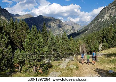 Hikers walking along Barrosa valley, a typical glacier valley of aragonese Pyrenees Huesca Spain View Large Photo Image Picture - Hikers walking along Barrosa valley, a typical glacier valley of aragonese Pyrenees Huesca Spain. Fotosearch