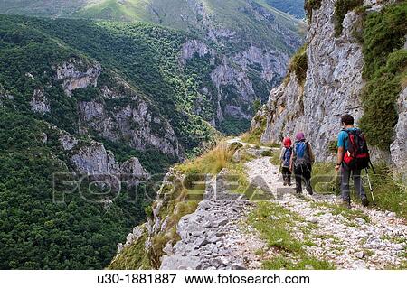 Hikers walking down from Tresviso, a small village in Picos de Europa National Park by historic Urd? n path to La Hermida Gorges Pearrubia Cantabria, Spain View Large Photo Image Stock Photo - Hikers walking down from Tresviso, a small village in Picos de Europa National Park by historic Urd? n path to La Hermida Gorges Pearrubia Cantabria, Spain. Fotosearch